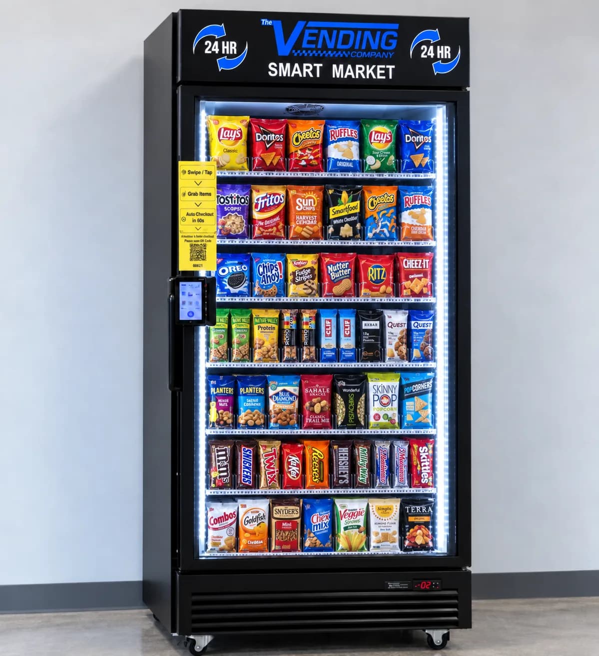 Glass-front snack vending machine stocked with chips, candy and bars